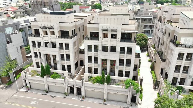 Aerial view of luxury neoclassical townhouse community in Chiayi, Taiwan. Modern stone facade residential villas. 4K Drone Orbit.