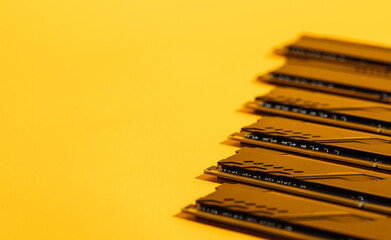 Diagonal row of black RAM modules on yellow background with copy space. High quality photo