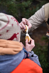 Roasted marshmallow with cookies in children's and adults' hands