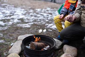 Roasting marshmallows in the backyard. Family fun