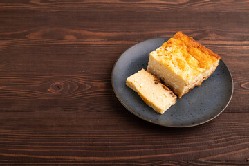 Сottage cheese Сasserole, Curd cake, with dried apricots and raisins on brown wooden, side view, copy space