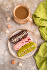 Glazed Eclairs on brown concrete on brown concrete, top view, flat lay, close up