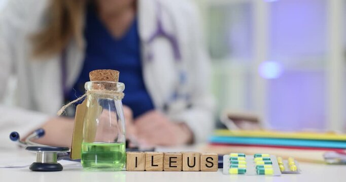 Word Ileus of cubes with medications and doctor reading medical records in hospital. Diagnostics of small bowel obstruction in healthcare facility