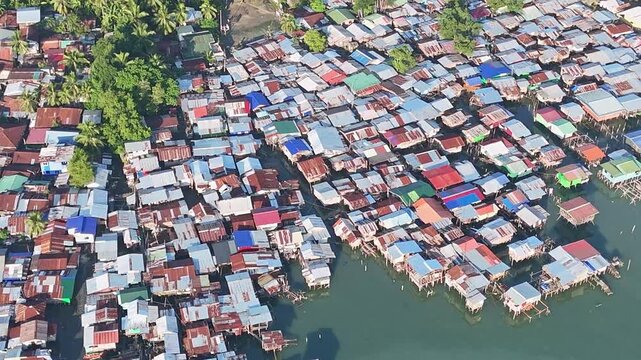 Thousands of stilt houses line the coast in poverty stricken neighborhoods in Davao City Philippines with no sanitation.