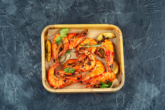Grilled langoustines in wooden box, luxury food.