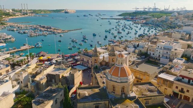 Drone view of fishing village Marsaxlokk and church. Malta island