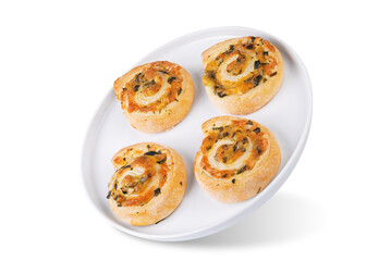 Basil garlic cheese roll cake pinwheel in a plate on a white isolated background