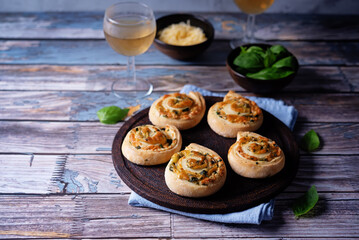 Basil garlic cheese roll cake pinwheel in a plate on a wood background