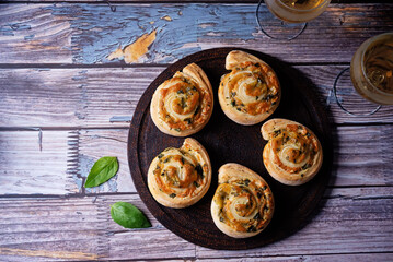 Basil garlic cheese roll cake pinwheel in a plate on a wood background