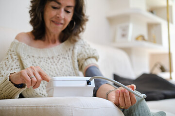 close up shot of confident Senior woman monitoring blood pressure at home