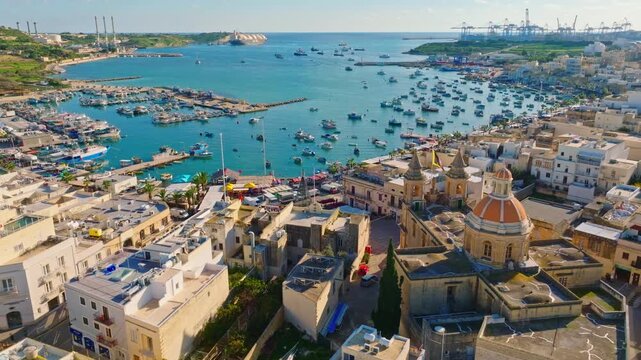 Fishing village Marsaxlokk and church. Drone view, Malta 
