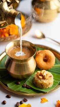 South Indian festive breakfast with filter coffee, sweet pongal, medu vada on banana leaf, traditional brassware serving, Pongal celebration meal, Tamil Nadu harvest festival setup