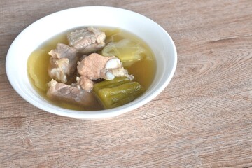 boiled pickled cabbage and bitter melon with pork bone  in clear soup on bowl 