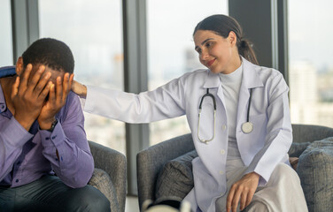 Obraz premium Doctor comforting depressed man during mental health consultation, showing empathy emotional support, psychiatric care and professional therapy in hospital for mental wellness, mental health awareness