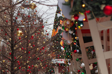 Christmas fair, advent market in a European town, happy shoppers buying gifts.