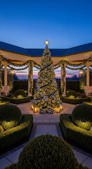 Festive Christmas tree decorated with silver baubles standing under an illuminated gazebo at dusk, conveying holiday magic.