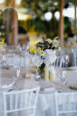 Vertical floral display with white blossoms and draping foliage