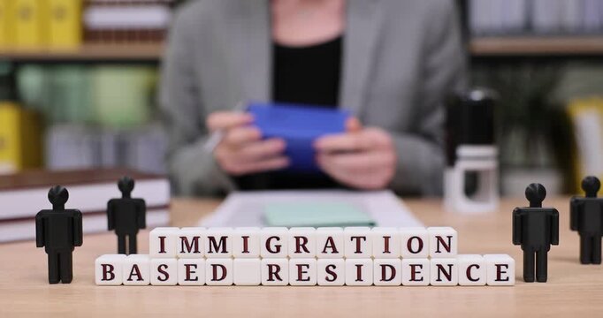 Exploring immigration based residence options while holding important documents at an office setting