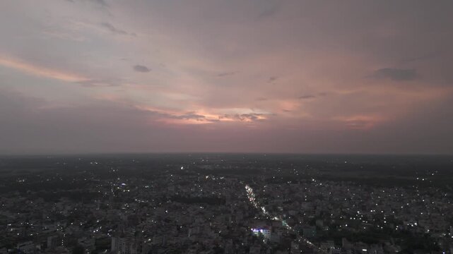 Wide Aerial View of Sprawling City Skyline at Dusk with Pink Sunset Sky and Urban Lights India
