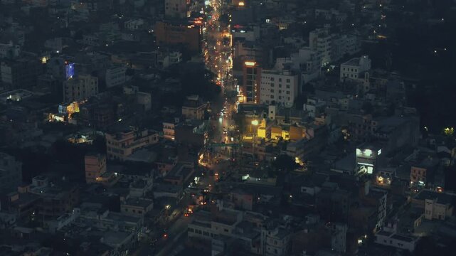 Aerial Night Timelapse of Busy City Street Traffic and Urban Glow in Metropolitan India Night