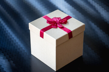 Contrasting Gift Box with Red Ribbon on Dark Textured Background, Luxury Holiday Present Concept
