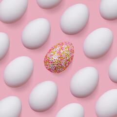 Sparkling and white easter eggs as creative pattern on pastel pink. Minimalist contemporary design, abstract aesthetic food. Decorative eggs with rhinestones or sequins as easter holidays background.