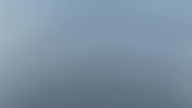 Aerial view of Haut-Koenigsbourg castle emerging from a sea of dense fog, contrasting with the clear blue sky, Orschwiller, Grand Est, France.