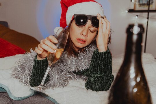 Fototapeta Drunk woman on new year's eve. The problem of alcoholism and loneliness during the Christmas and New Year holidays
