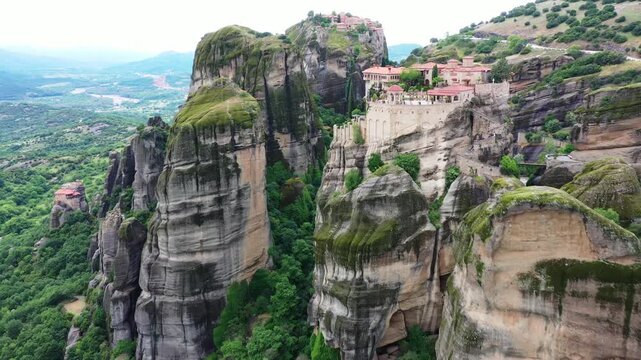 Aerial view of the Meteora Monasteries perched atop towering rock formations, a stunning blend of nature and architecture, Kalampaka, Trikala, Greece.
