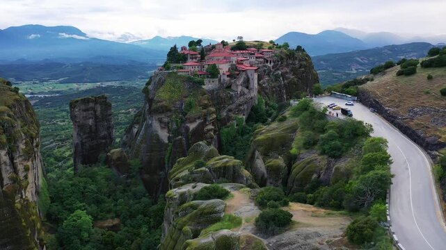 Aerial view of Meteora Monasteries, perched atop towering rock formations, a blend of nature's grandeur and human endeavor, Kalampaka, Trikala, Greece.
