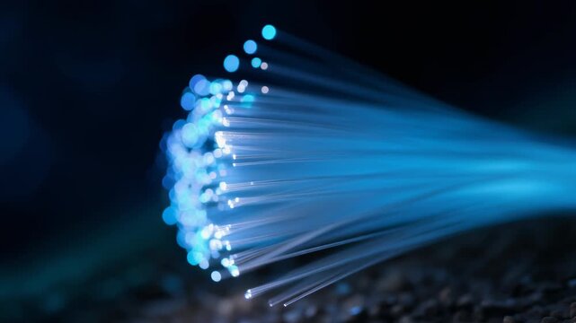 Stunning close-up of glowing fiber optic strands in a dark blue background for digital technology themes