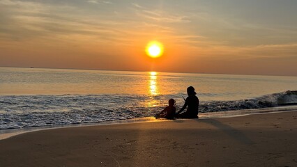 Big sun and sea sunset, Copy space of soft sand sea and blur tropical beach with sunset sky and cloud abstract background. landscape - sunset on the coast, waves, horizon. top view. Beautiful colorful