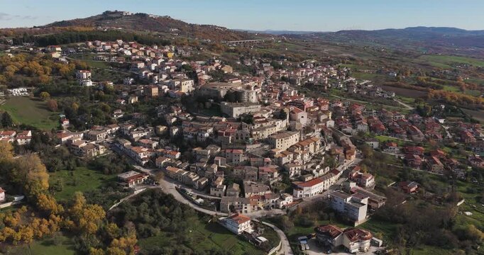 Aerial view of Gesualdo, its ancient castle standing proudly amidst a sea of terracotta roofs and verdant hillsides, Irpinia, Campania, Italy.