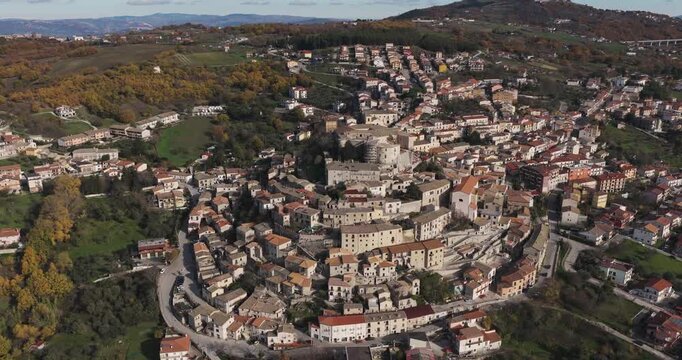 Aerial view of Gesualdo Castle and surrounding buildings, a tapestry of terracotta roofs contrasting with the stone structures, nestled within Irpinia, Campania, Italy.