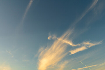 Golden Sunset Clouds in Clear Blue Sky Background