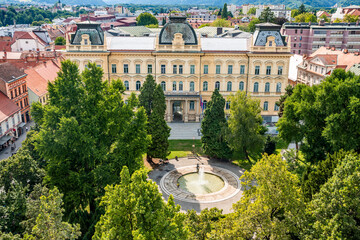 Facade of the Rectorate of the University of Maribor, historic academic building surrounded by a green park on Slomskov Trg square, Maribor city center, Slovenia.