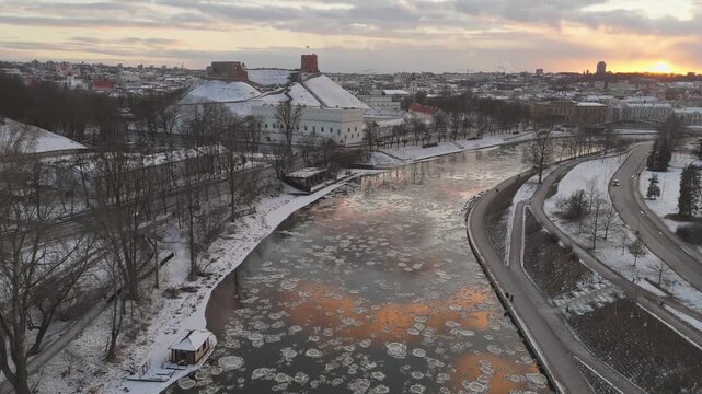 Aerial view of the river with ice floes reflecting the sunset near Gediminas' Tower, a winter scene, Vilnius, Lithuania.