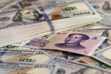 Overlapping Collage of US Dollar and Chinese Yuan Banknotes