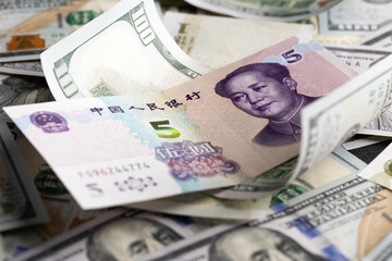 Overlapping Collage of US Dollar and Chinese Yuan Banknotes