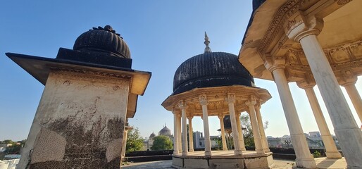 Traditional Rajasthani Cenotaphs  and Tall Columns, Showcasing Intricate Architectural Heritage and Weathered Stone Structures in Mandawa, Rajasthan, India