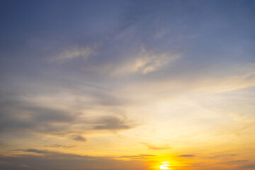 Fototapeta premium Sunset sky clouds background. Beautiful landscape with clouds and orange sun on sky,Orange sky and clouds background,Background of colorful sky concept, amazing sunset with twilight sky and clouds.