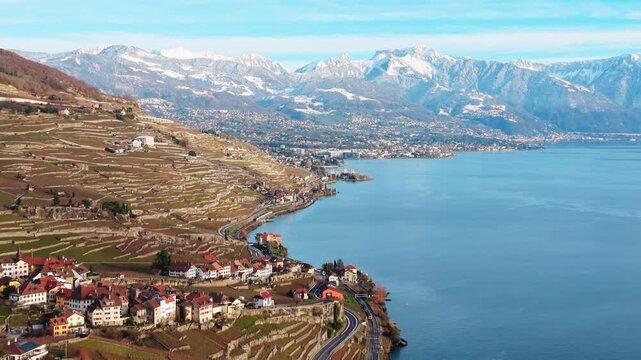 Aerial view of Lavaux Vineyard Terraces, a UNESCO world heritage site, with snow-capped mountains in the background, Bourg-en-Lavaux, Vaud, Switzerland.