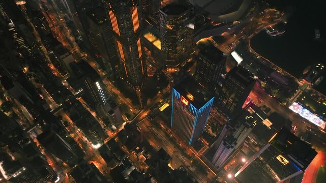 Aerial view of Kowloon island skyscrapers at night, with vibrant lights illuminating the streets and buildings, Kowloon, Kowloon, Hong Kong.
