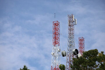 Tower crane and communication antenna on a steel structure construction site against a blue sky, representing wireless telecommunication network technology and the building industry
