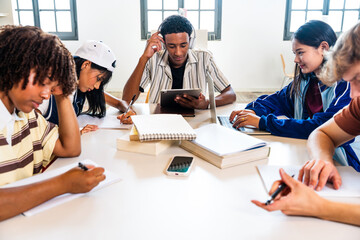 Diverse group of students studying together at library