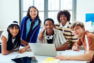 Fototapeta premium Multiethnic students studying together smiling at library