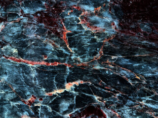 Dark blue and black marble texture background with red and gold veins