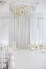 Elegant wedding altar surrounded by soft blooms and candles in a serene venue