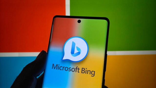 Smartphone displaying the microsoft bing logo and name against a colorful background