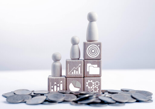 The image of stacked wooden cubes arranged in a staircase, along with various icons, symbolizes the step-by-step process of achieving goals, organizational growth, success, and strategic planning.